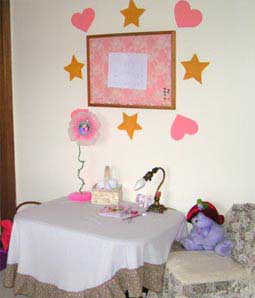 I created a craft area with a table for her to do crafts, a fancy chair and a corkbpard to display her art.